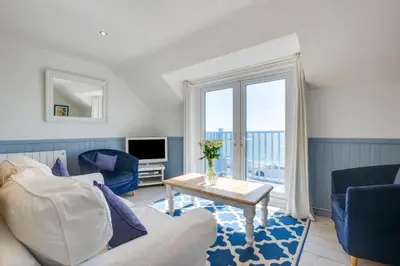 a living room with a couch and a table at 2 Bed in Porthleven oc-clifto in Porthleven