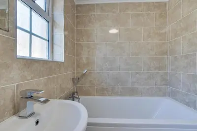 a bathroom with a white tub and a sink at 2 Bed in Porthleven oc-clifto in Porthleven