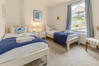 a bedroom with two beds and a window at 4 Bed in Fowey oc-chview in Fowey