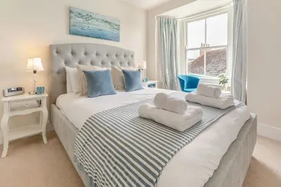 a bedroom with a large bed with two pillows on it at 4 Bed in Fowey oc-chview in Fowey