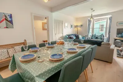 a dining room table with a green table cloth at 4 Bed in Fowey oc-chview in Fowey