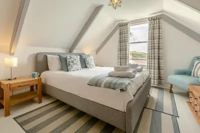 a bedroom with a bed and a window at 4 Bed in Fowey oc-chview in Fowey