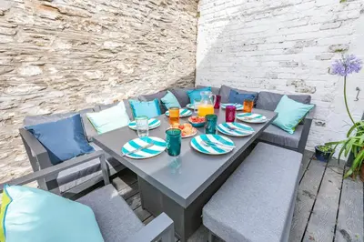 a table with plates of food and drinks on it at 4 Bed in Fowey oc-chview in Fowey