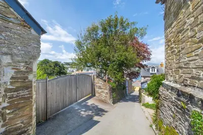 an alley in a home with a wooden fence at 5 Bed in Polruan oc-ccmead in Fowey