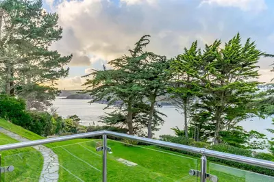 a balcony with a view of the water at 5 Bed in Polruan oc-ccmead in Fowey