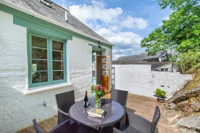 a patio with a table and chairs and a building at 2 Bed in Fowey oc-ccoun2 in Fowey