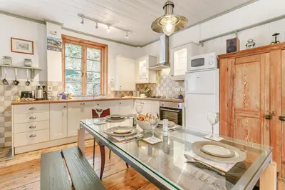 a kitchen with a glass table and a white refrigerator at 2 Bed in Fowey oc-ccoun2 in Fowey