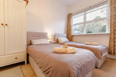 a bedroom with two beds and a window at 2 Bed in Fowey oc-ccoun2 in Fowey