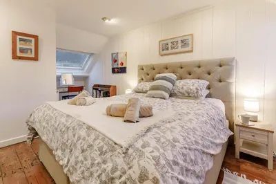 a bedroom with a large bed with two pillows on it at 2 Bed in Fowey oc-ccoun2 in Fowey