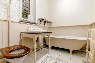 a bathroom with a tub and a toilet and a sink at 2 Bed in Fowey oc-ccoun2 in Fowey