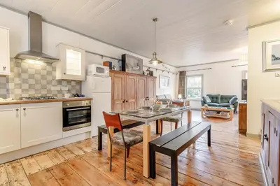 a kitchen with a table and a dining room at 2 Bed in Fowey oc-ccoun2 in Fowey