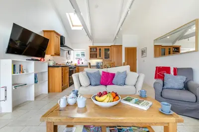 a living room with a bowl of fruit on a coffee table at 2 Bed in Polruan oc-cgart2 in Fowey