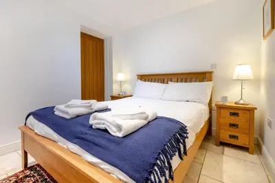 a bedroom with a bed with towels on it at 2 Bed in Polruan oc-cgart2 in Fowey
