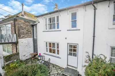 an exterior view of a white house with a porch at 2 Bed in Polruan oc-cgart2 in Fowey