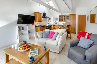 a living room with two couches and a table at 2 Bed in Polruan oc-cgart2 in Fowey
