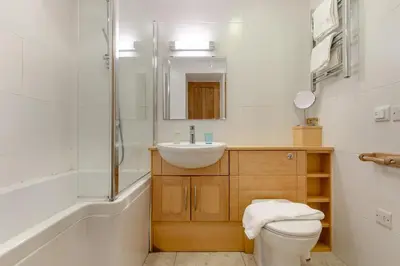 a bathroom with a toilet and a sink and a shower at 2 Bed in Polruan oc-cgart2 in Fowey