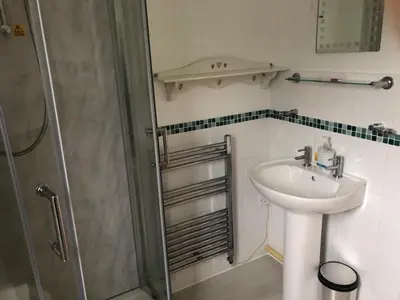 a bathroom with a sink and a shower at Cosy 3 Bedroom House on Cornish estate with pool in Bodmin