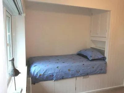 a small bedroom with a bed in a wall at Cornwall family friendly villa with free use of Pool, soft play, mini golf, tennis, gym, fitness classes, sauna and ice baths in Newquay