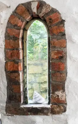a painting of a window in a brick wall at Lovely cottage with private garden in Penryn