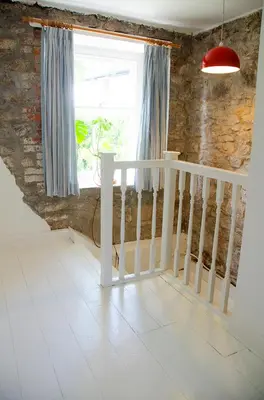 a room with a staircase and a window and a stair case at Lovely cottage with private garden in Penryn