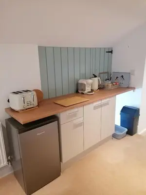 a kitchen with a counter with a toaster oven on it at The Prince of Wales in Helston