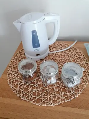a coffee maker and three jars on a table at The Prince of Wales in Helston