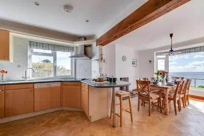 a kitchen and dining room with a table and chairs at 4 Bed in Fowey oc-cridg2 in Fowey