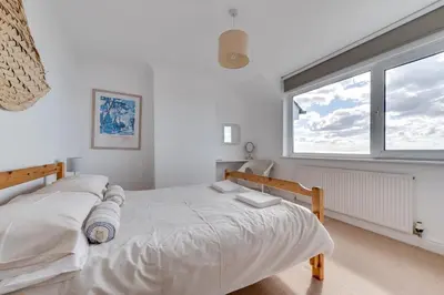 a bedroom with a bed and a large window at 4 Bed in Fowey oc-cridg2 in Fowey