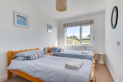 two beds in a room with a window at 4 Bed in Fowey oc-cridg2 in Fowey