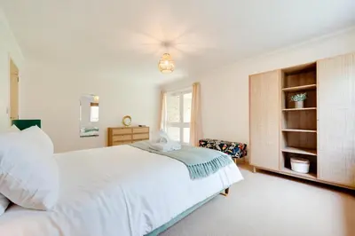 a bedroom with a large white bed and a window at 2 Bed in Carlyon Bay oc-crinni in Carlyon Bay