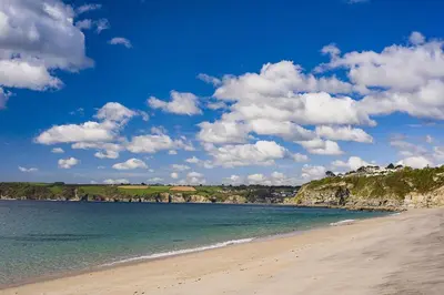 a beach with the ocean and a blue sky and clouds at 2 Bed in Carlyon Bay oc-crinni in Carlyon Bay
