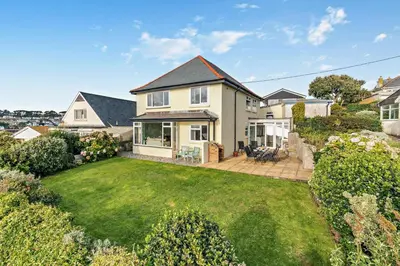 a house with a large yard with a lawn sidx sidx sidx at 4 Bed in Polruan oc-csclif in Fowey