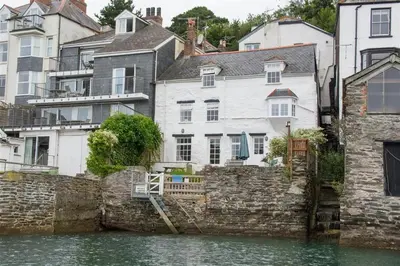 a group of houses next to a body of water at 3 Bed in Fowey oc-cstepa in Fowey