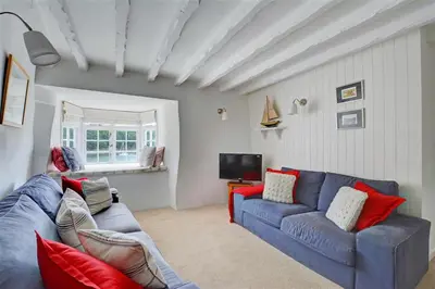 a living room with a blue couch and a tv at 3 Bed in Fowey oc-cstepa in Fowey