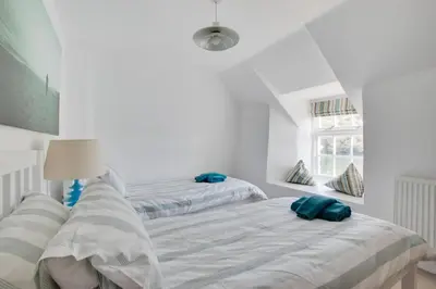 two beds in a bedroom with white walls at 3 Bed in Fowey oc-cstepa in Fowey