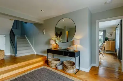 a living room with a table and a mirror at 4 Bed in Mawgan Porth oc-d26830 in Mawgan Porth