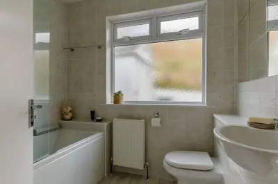 a bathroom with a tub and a toilet and a sink at 4 Bed in Mawgan Porth oc-d26830 in Mawgan Porth