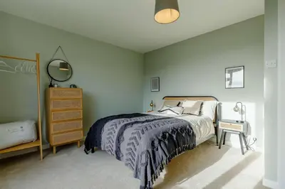 a bedroom with a bed and a dresser at 4 Bed in Mawgan Porth oc-d26830 in Mawgan Porth