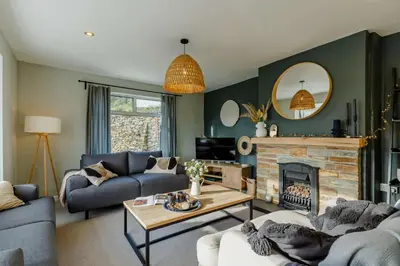 a living room with two couches and a fireplace at 4 Bed in Mawgan Porth oc-d26830 in Mawgan Porth