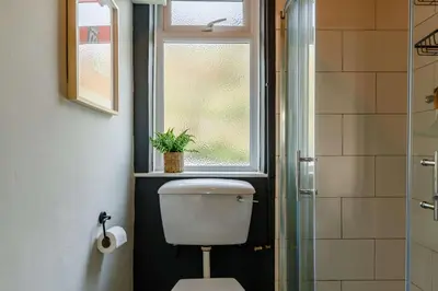a bathroom with a toilet and a window at 4 Bed in Mawgan Porth oc-d26830 in Mawgan Porth