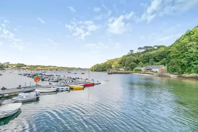 a group of boats docked at a dock on a river at 3 Bed in Helford oc-dowrpe in Helford