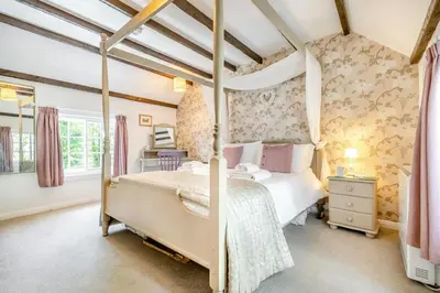 a bedroom with a four poster bed in a room at 3 Bed in Helford oc-dowrpe in Helford