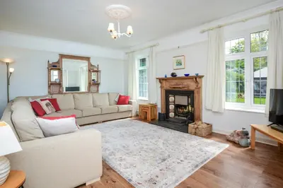 a living room with a couch and a fireplace at 4 Bed in Pentewan oc-edghil in Pentewan