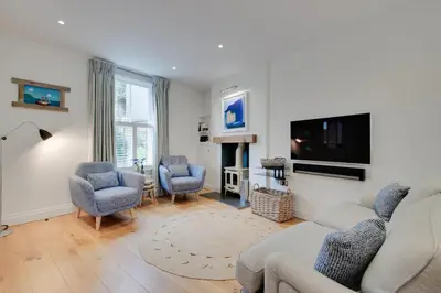 a living room with a couch and chairs and a tv at 2 Bed in Fowey oc-forty in Fowey