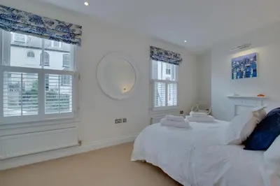 a white bedroom with a bed and a window at 2 Bed in Fowey oc-forty in Fowey