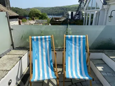 two blue and white chairs sitting on a roof at 2 Bed in Fowey oc-forty in Fowey