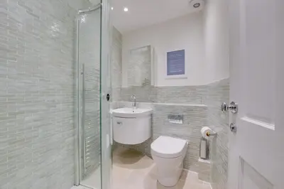 a bathroom with a toilet and a sink and a shower at 2 Bed in Fowey oc-forty in Fowey