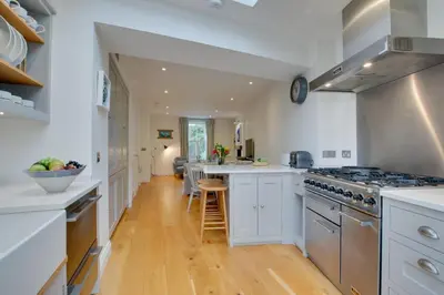 a kitchen with white cabinets and a stove top oven at 2 Bed in Fowey oc-forty in Fowey