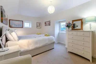a white bedroom with a bed and a dresser at 2 Bed in Redruth oc-gbells in Porkellis