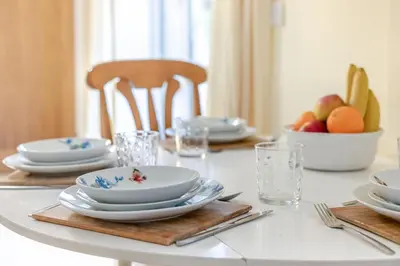 a dining room table with plates and bowls of fruit at 2 Bed in Redruth oc-gbells in Porkellis